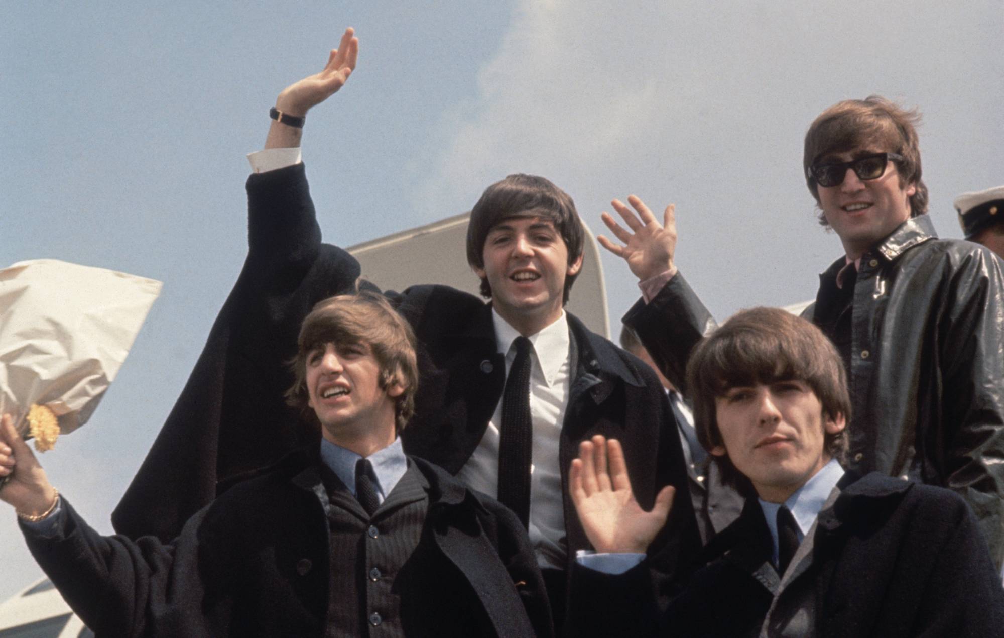 The Beatles (from left to right, John Lennon (1940 - 1980), George Harrison (1943 - 2001), Paul McCartney and Ringo Starr) arrive back at London Airport after their Australian tour. (Photo by Fox Photos/Getty Images)