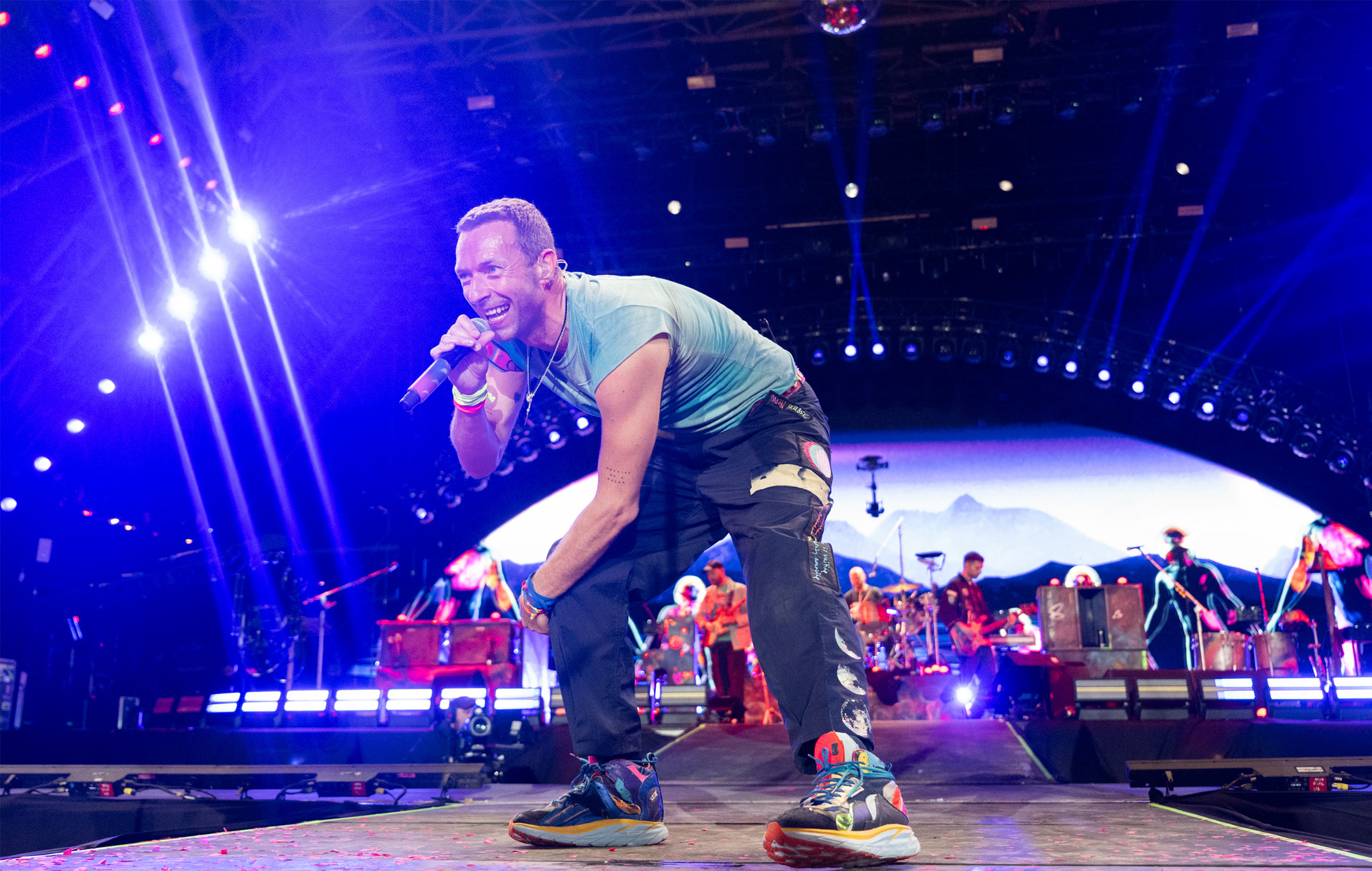 Chris Martin of Coldplay performing at Glastonbury 2024