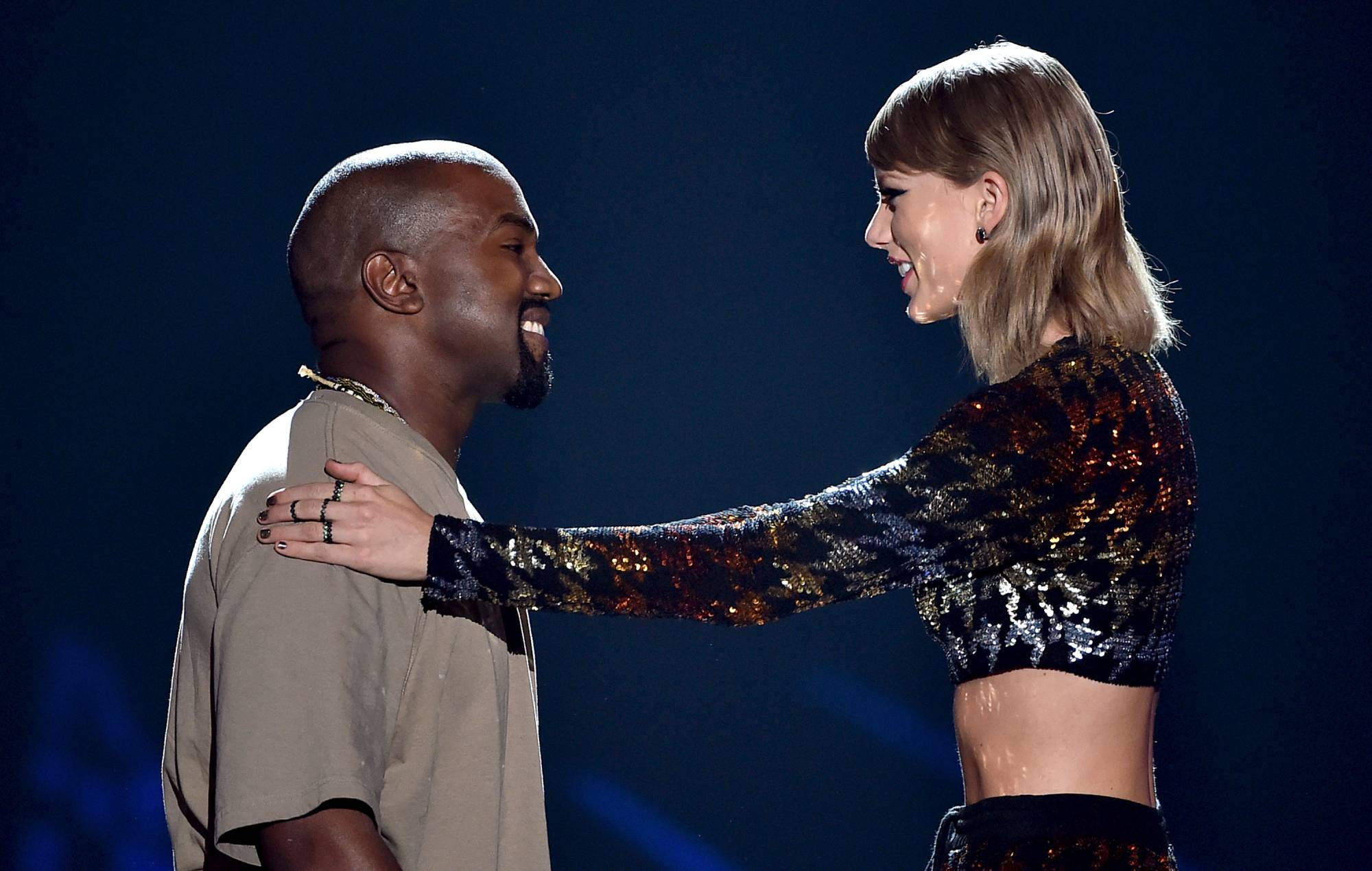  Kanye West (L) accepts the Video Vanguard Award from recording artist Taylor Swift onstage during the 2015 MTV Video Music Awards at Microsoft Theater on August 30, 2015 in Los Angeles, California. (Photo by Kevin Winter/MTV1415/Getty Images For MTV)